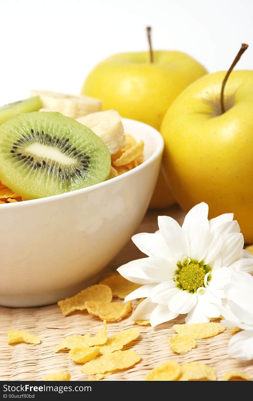 Healthy breakfast.Cornflakes and fruits with flower.