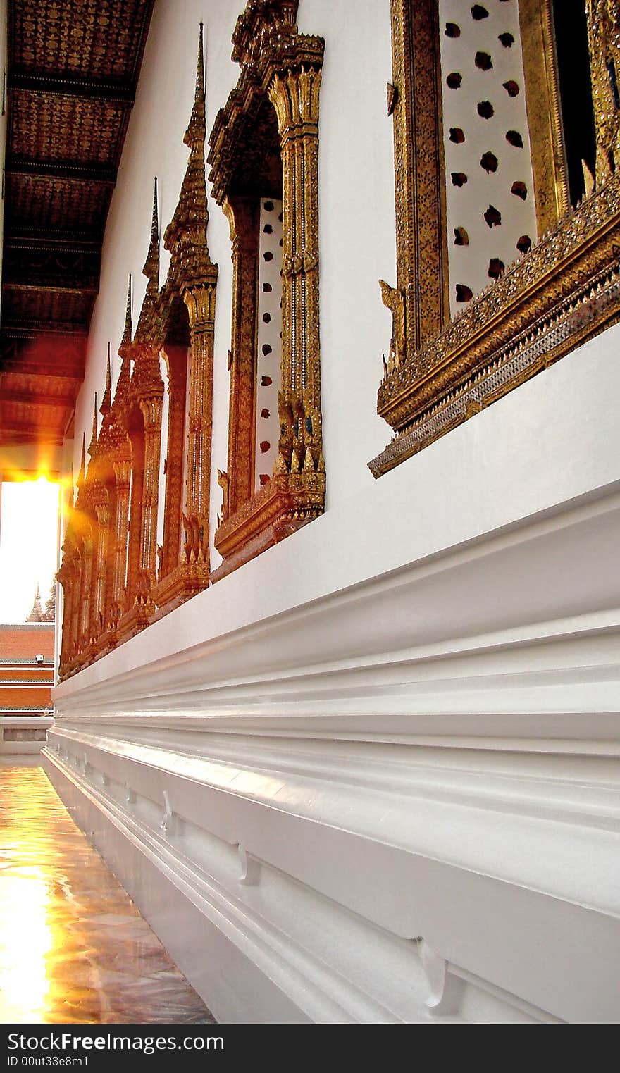 Wall of the Thai temple lit by evening sun. Wall of the Thai temple lit by evening sun