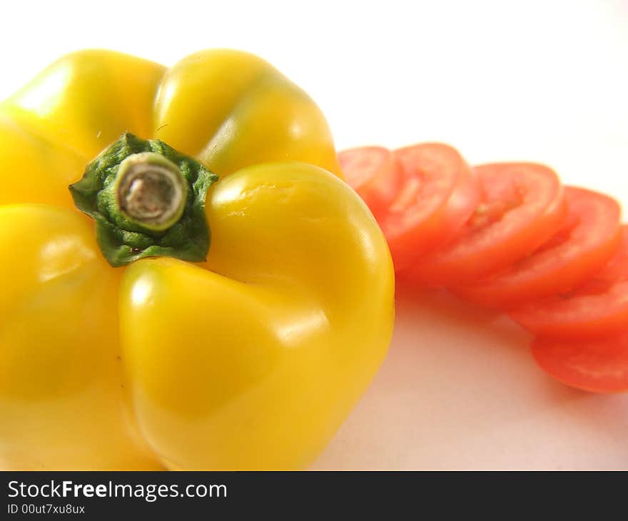 Photo of yellow capsicum and cut tomato. Photo of yellow capsicum and cut tomato