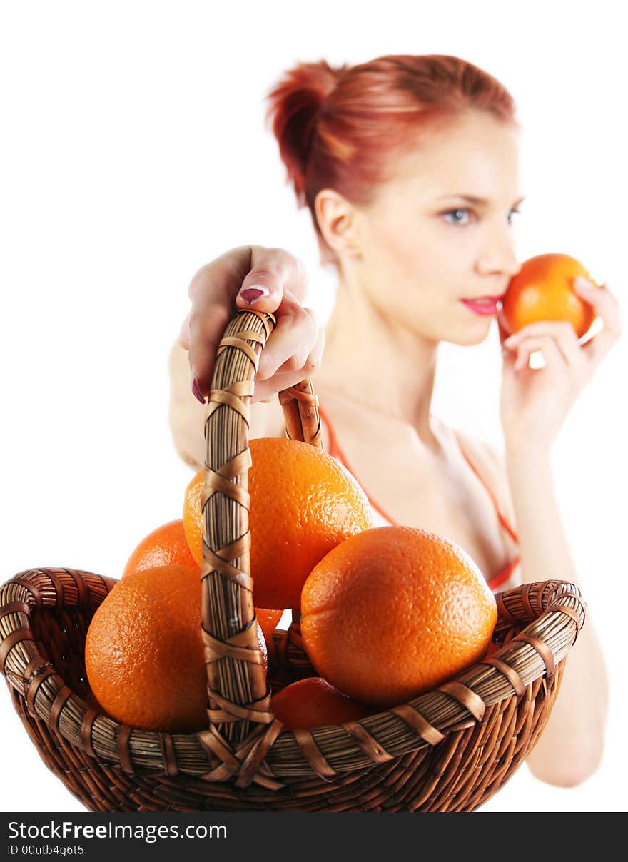 Redhead girl with basket of fresh oranges. Redhead girl with basket of fresh oranges