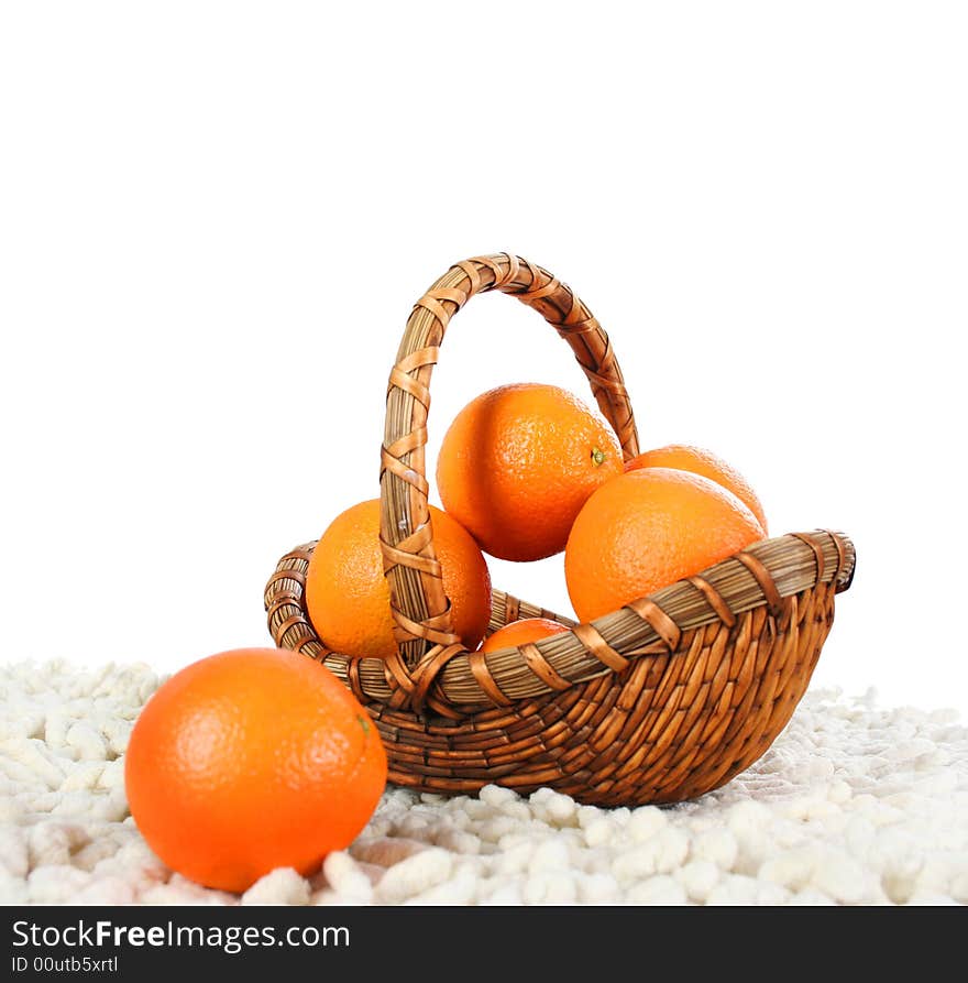 Basket with oranges isolated on white background