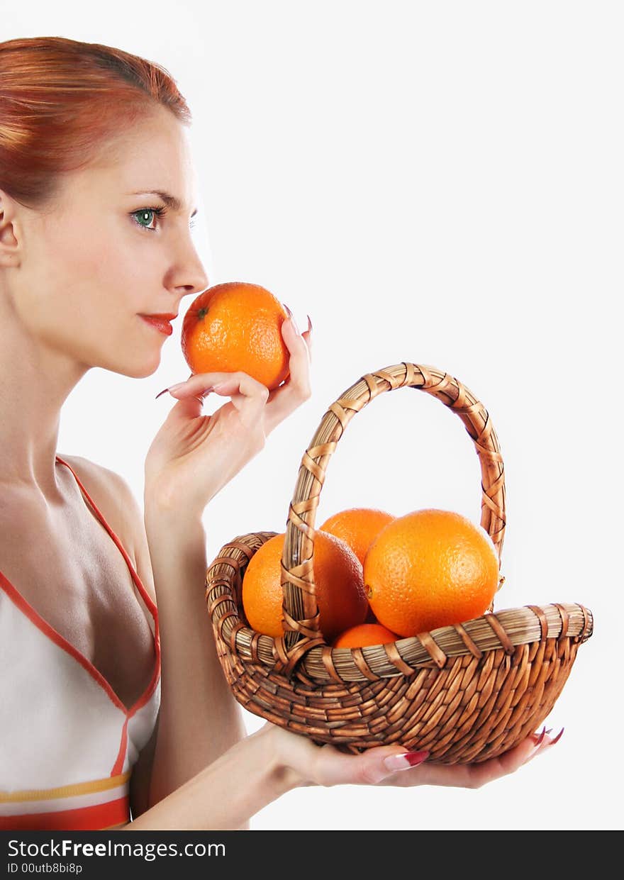 Redhead girl with basket of fresh oranges. Redhead girl with basket of fresh oranges