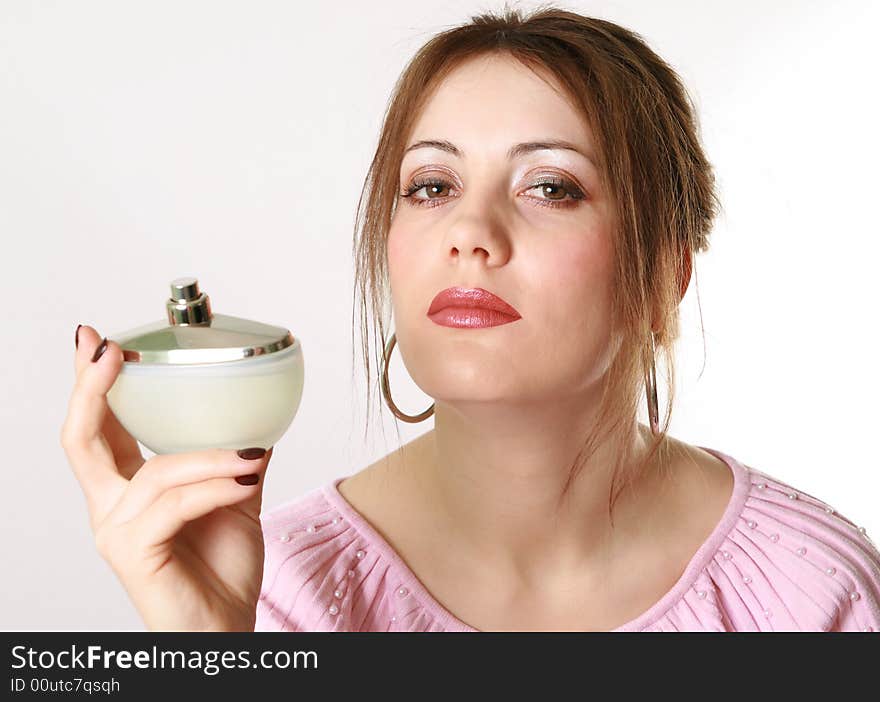 Beautiful woman applying perfume on her body. Beautiful woman applying perfume on her body