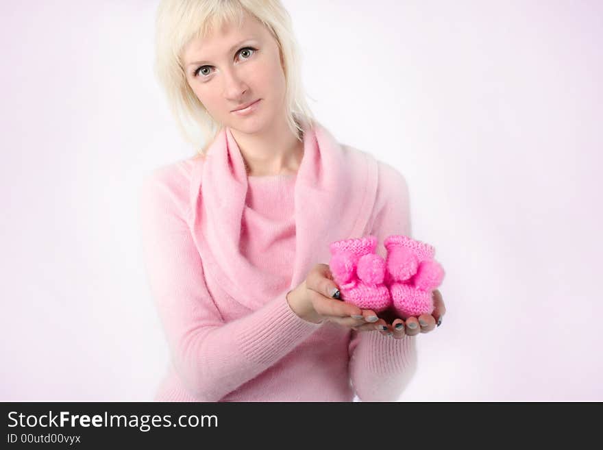 Young mother with little pink shoes