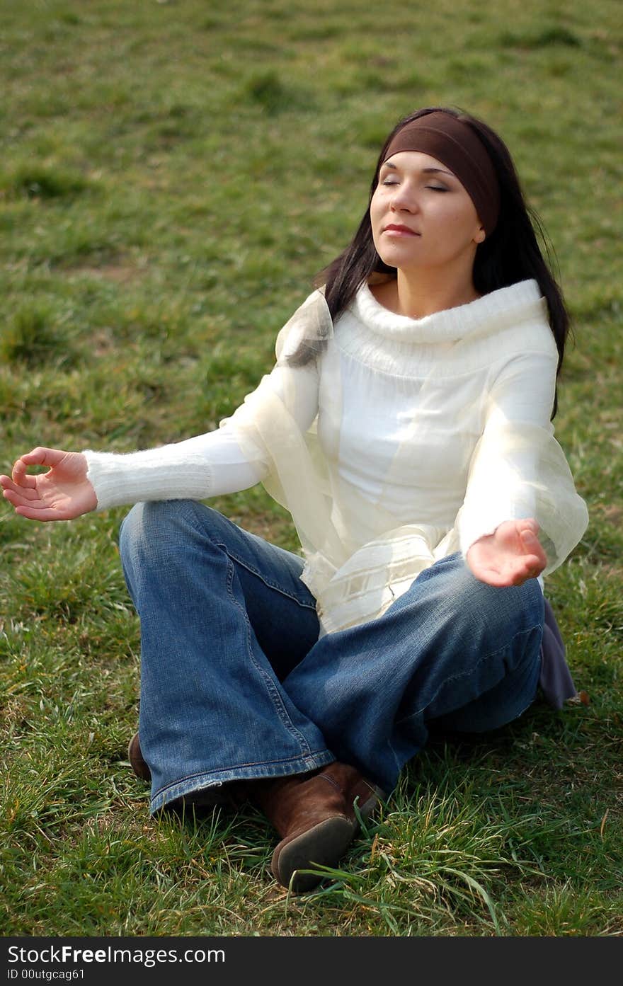 Attractive brunette woman relaxing on grass. Attractive brunette woman relaxing on grass