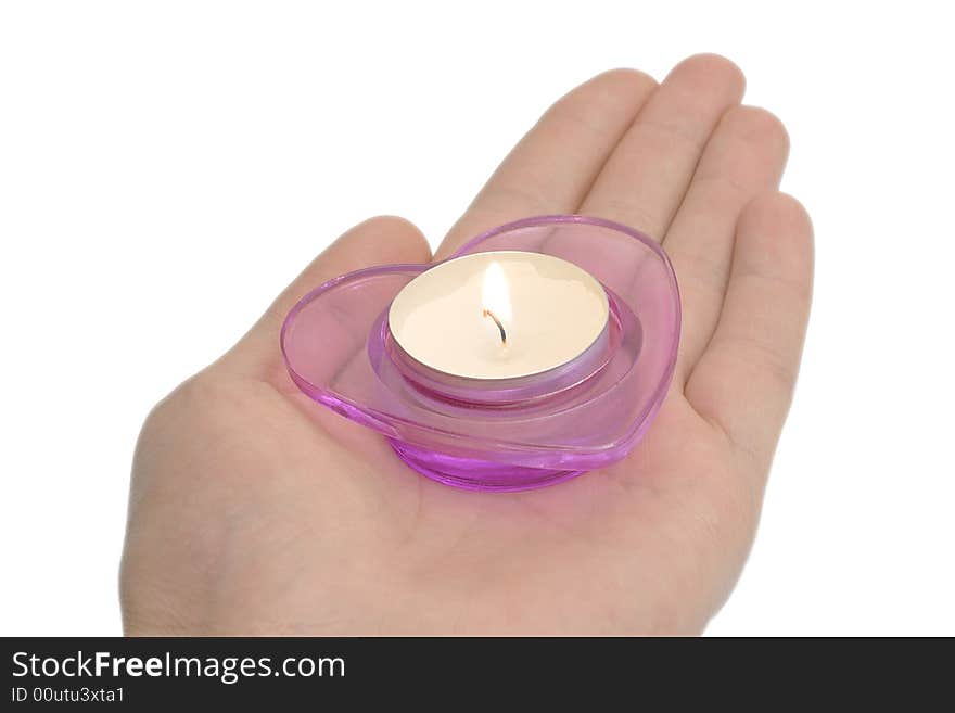 A magenta candlestick on the hand isolated over white. A magenta candlestick on the hand isolated over white