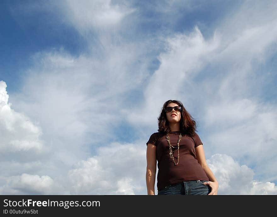 Woman with sunglasses against a blue sky. Woman with sunglasses against a blue sky.