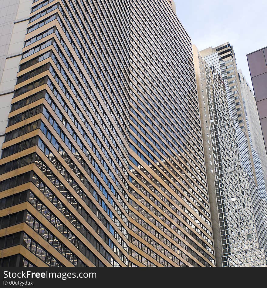 Reflections off the windows of a brick and glass facade