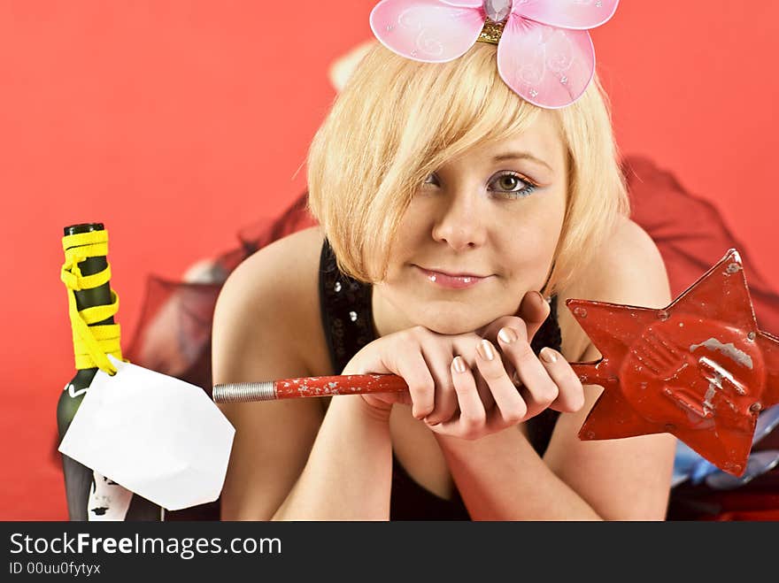 Girl looking at camera. Hand-made bottle with clear label. Girl looking at camera. Hand-made bottle with clear label