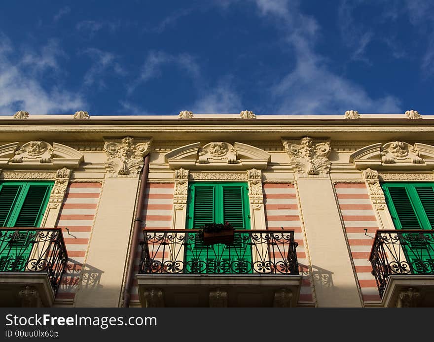 Classic italian facade with cute balconies defined against the blue sky. Classic italian facade with cute balconies defined against the blue sky