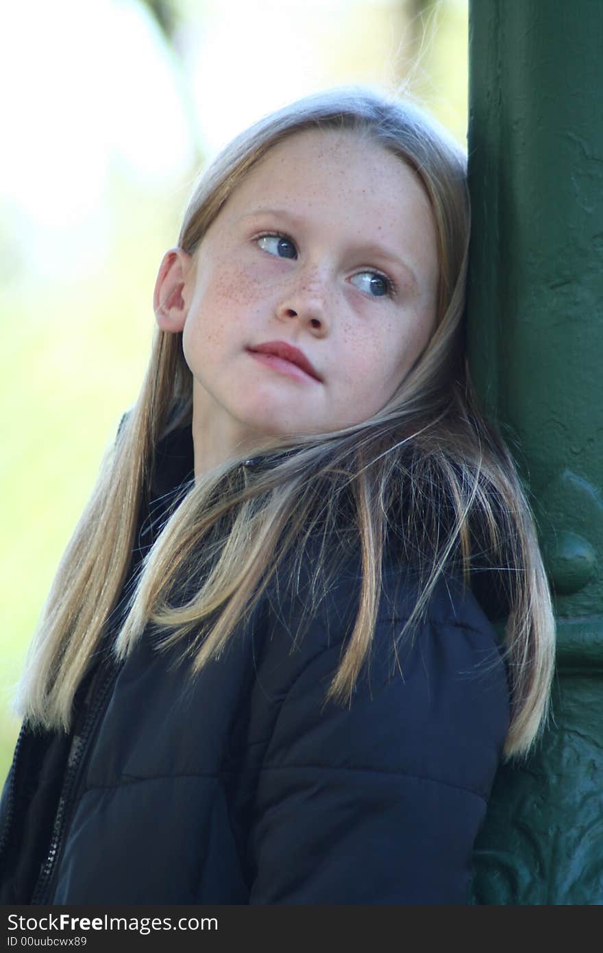 A white caucasian girl child with a bored expression on her face. A white caucasian girl child with a bored expression on her face