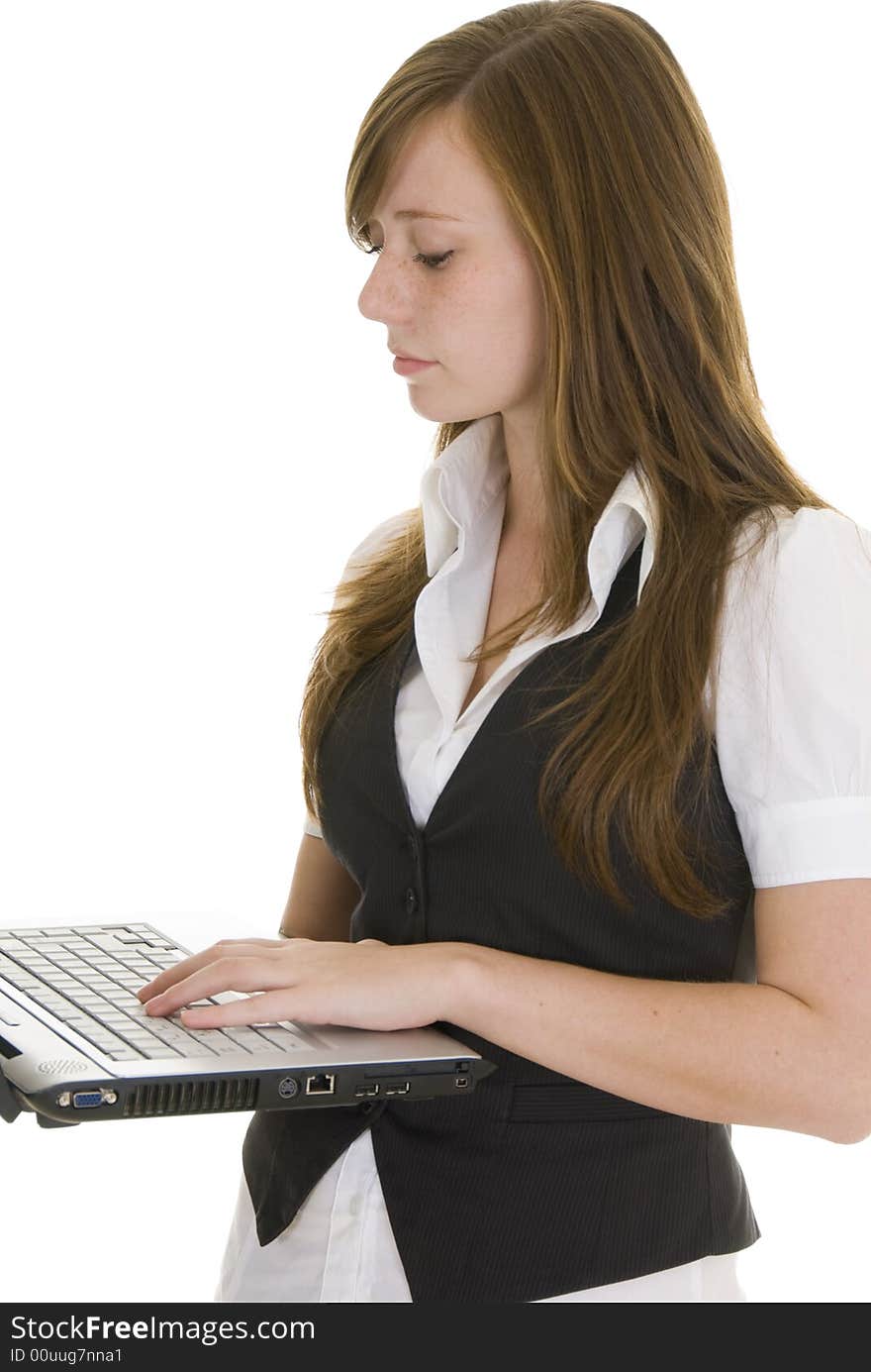 Pretty young lady dressed in black and white business attire isolated on white background, holding a laptop computer. Pretty young lady dressed in black and white business attire isolated on white background, holding a laptop computer.