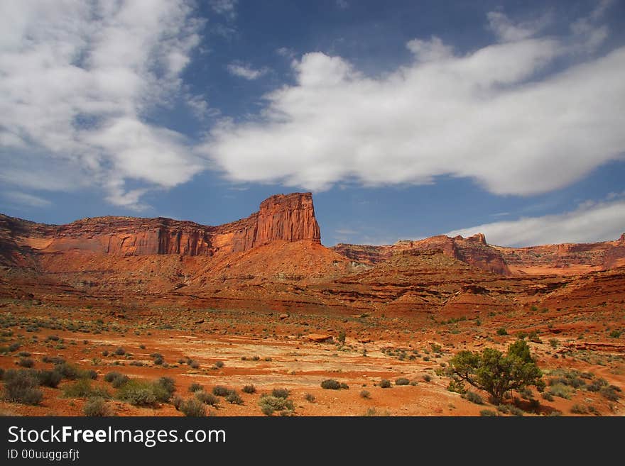 View of the red rock formations in Canyonlands National Park with blue sky�s and clouds. View of the red rock formations in Canyonlands National Park with blue sky�s and clouds