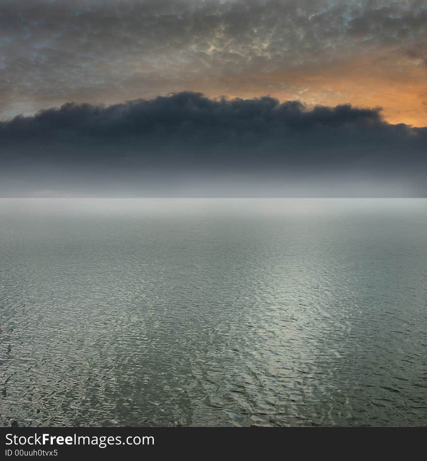 Its a lake, with black, dark clouds. Its a lake, with black, dark clouds