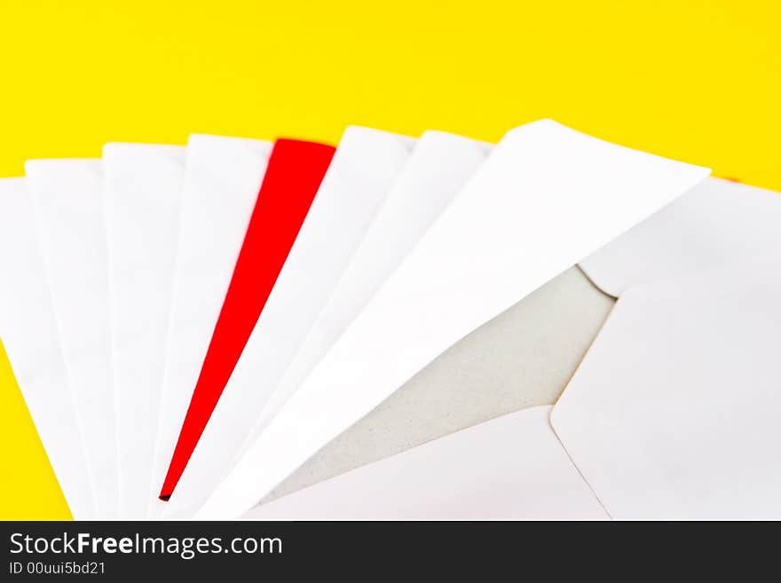 One red and seven white envelopes on a yellow background. One red and seven white envelopes on a yellow background