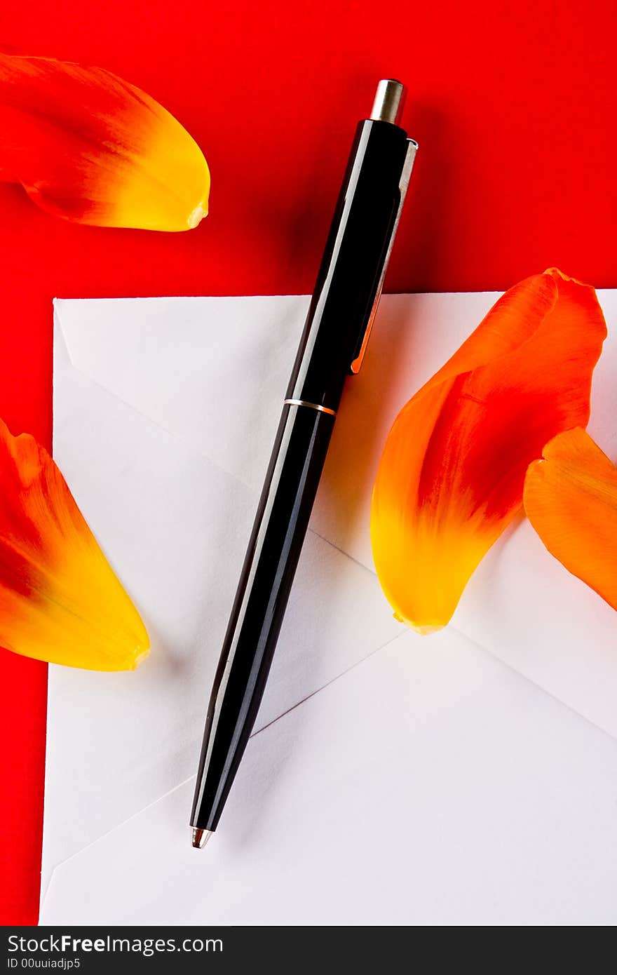 Pen and petals on a white envelope