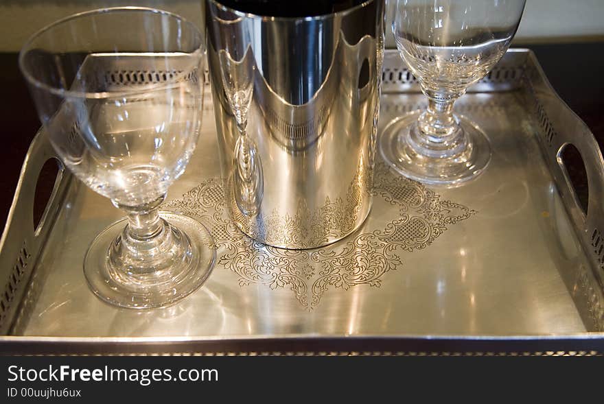 Silver tray with empty wine glasses.