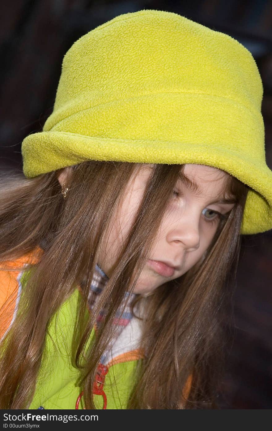 Little pretty thoughtful girl wearing a green hat. Little pretty thoughtful girl wearing a green hat