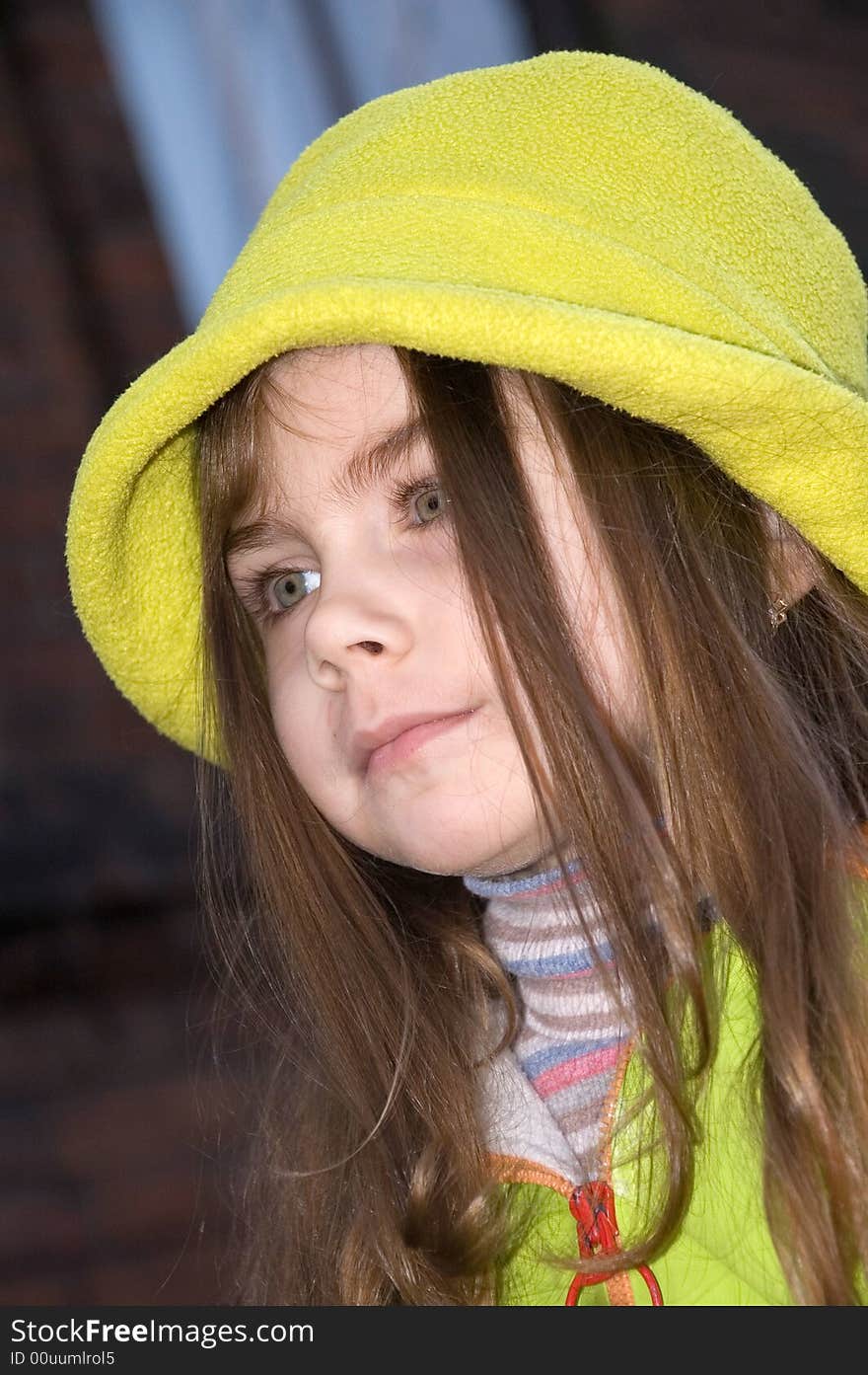 Little pretty girl wearing a green hat