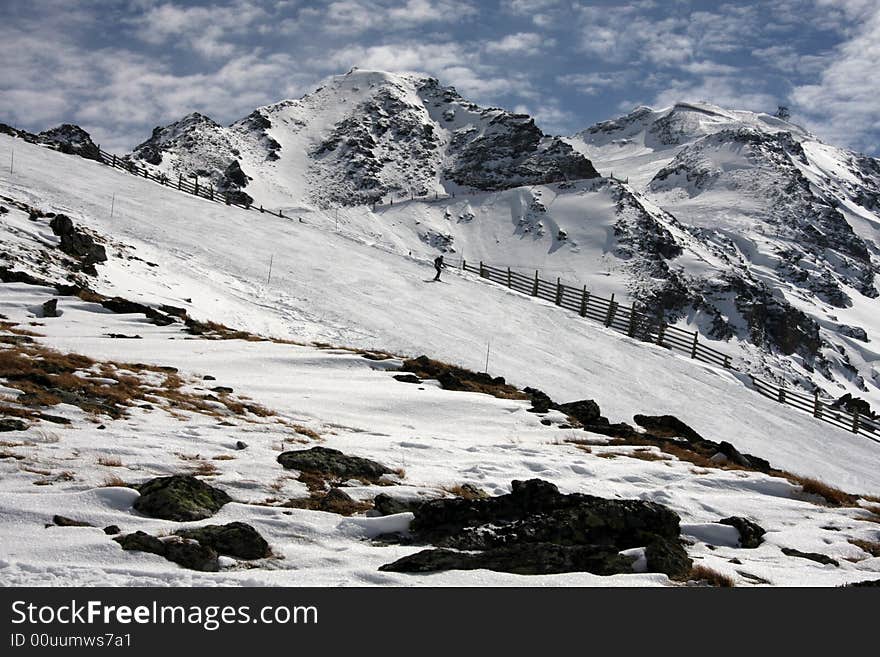 Skier skis down the wide mountain slopes. Skier skis down the wide mountain slopes