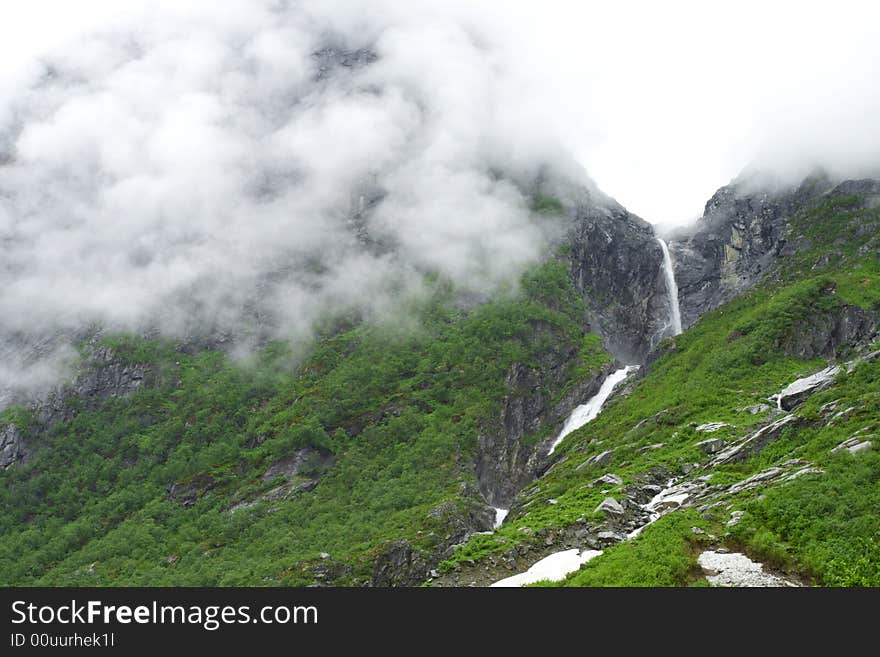 Fog in the mountains, waterfall, summer