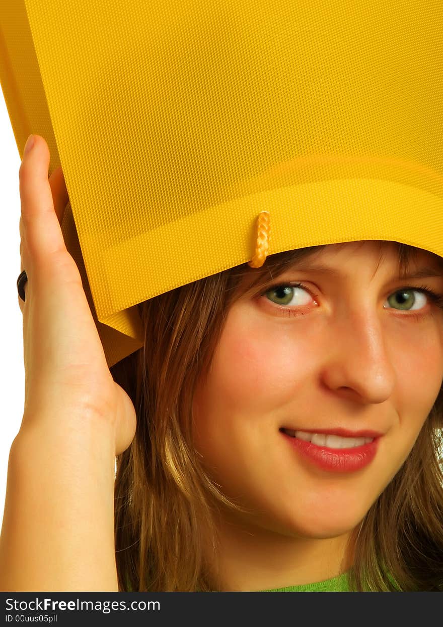 A pretty blond girl put a yellow shopping bag on her head. A pretty blond girl put a yellow shopping bag on her head