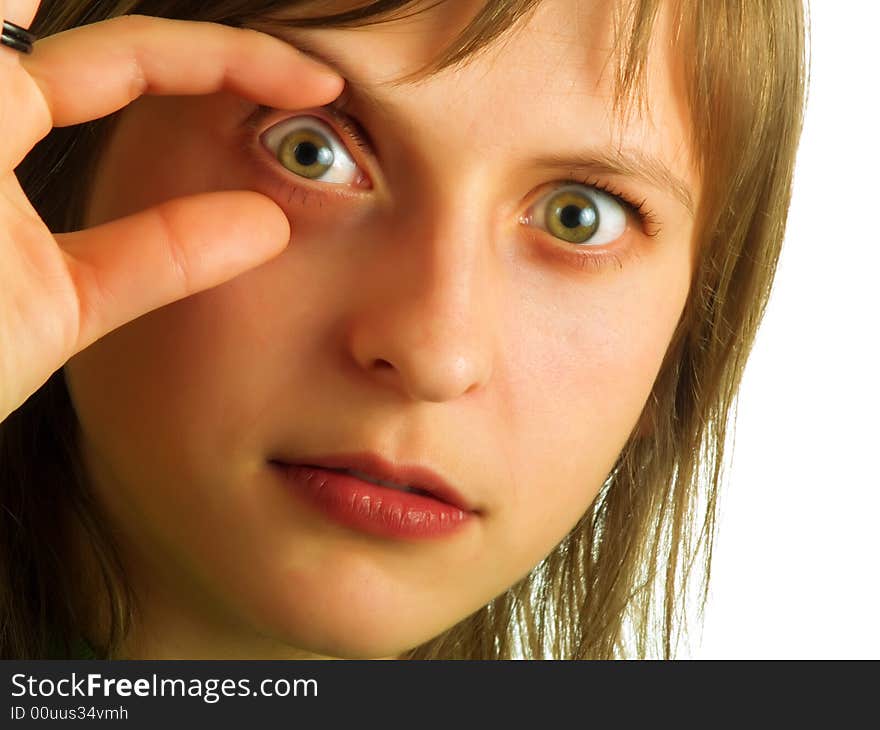 A pretty blond girl is showing one of her eyes to an oculist. A pretty blond girl is showing one of her eyes to an oculist