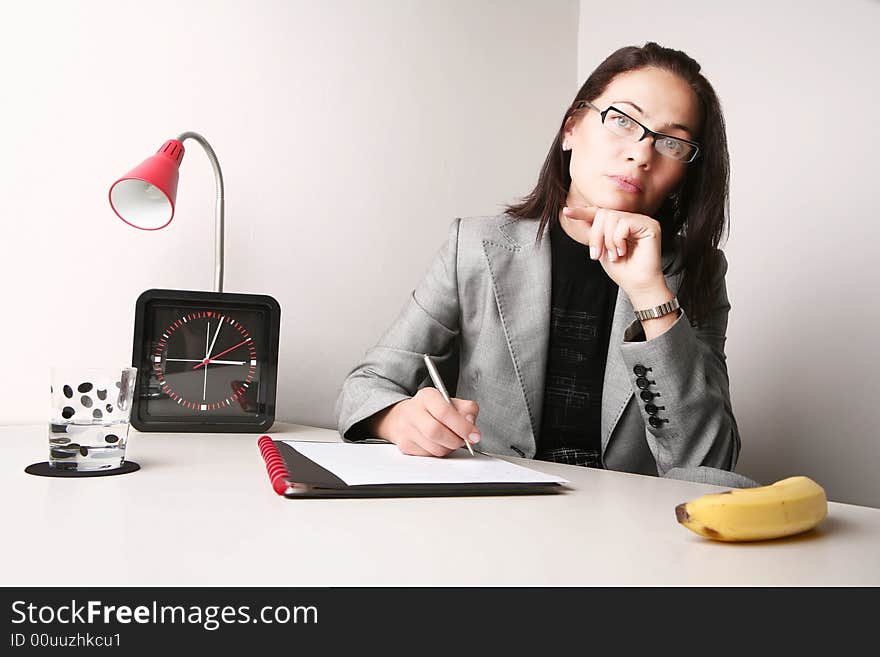 Good looking adult woman working at the office. Probably waiting for lunch. Good looking adult woman working at the office. Probably waiting for lunch...