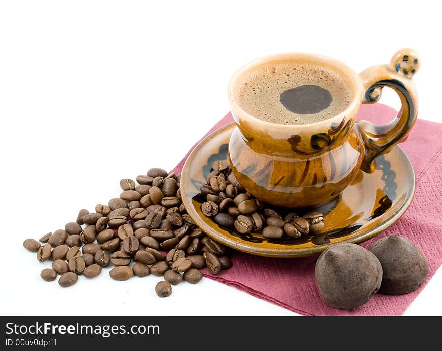 Coffee beans and black coffee in a cup isolated on a white background