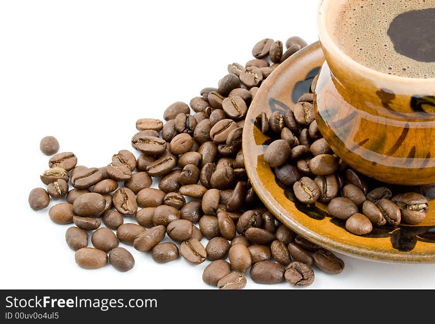 Coffee beans and black coffee in a cup isolated on a white background