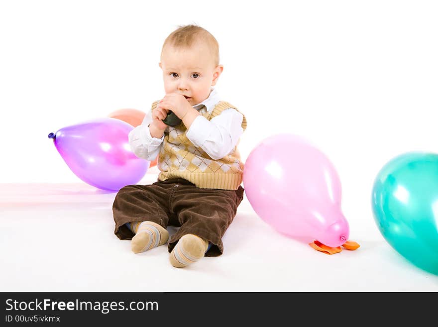 Boy of one year old tries to inflate a balloon. Boy of one year old tries to inflate a balloon