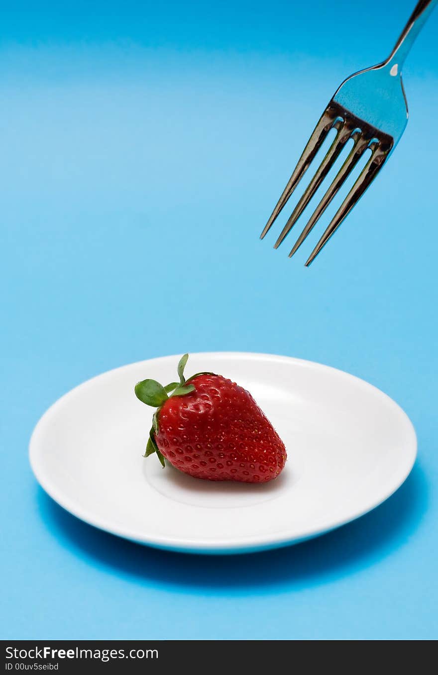 Strawberry with fork. Close up. Strawberry with fork. Close up.