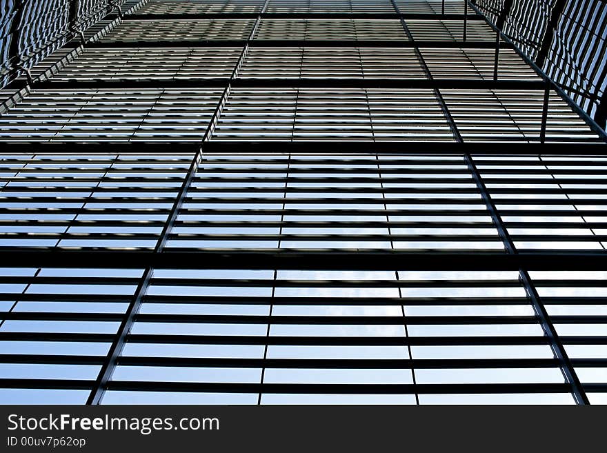 Abstract glass building facade with parallel metal details. Abstract glass building facade with parallel metal details