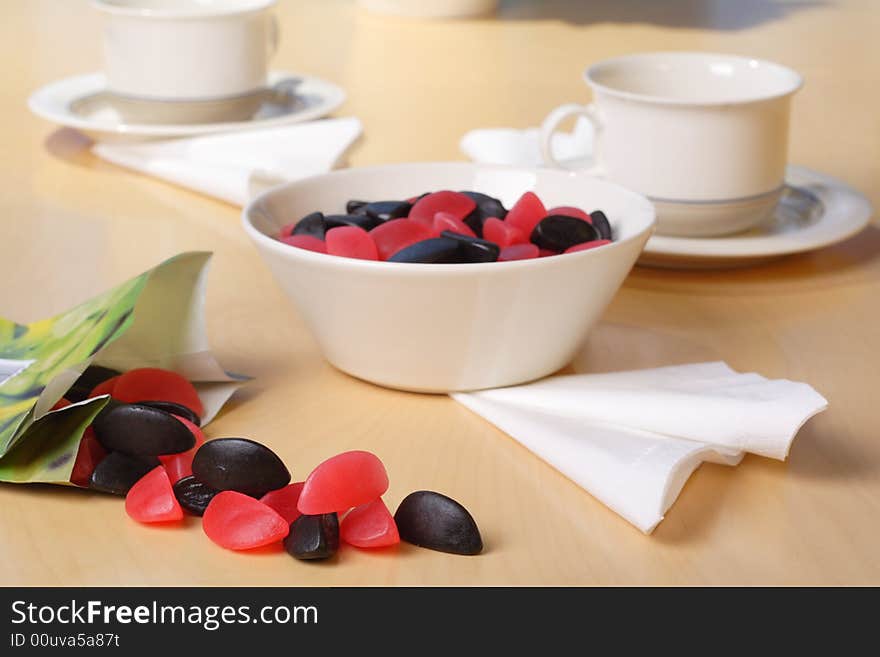 Candy with coffee cups in the background. Candy with coffee cups in the background