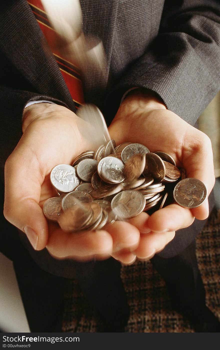 Man keeps in hands much placer metallic coins. Man keeps in hands much placer metallic coins