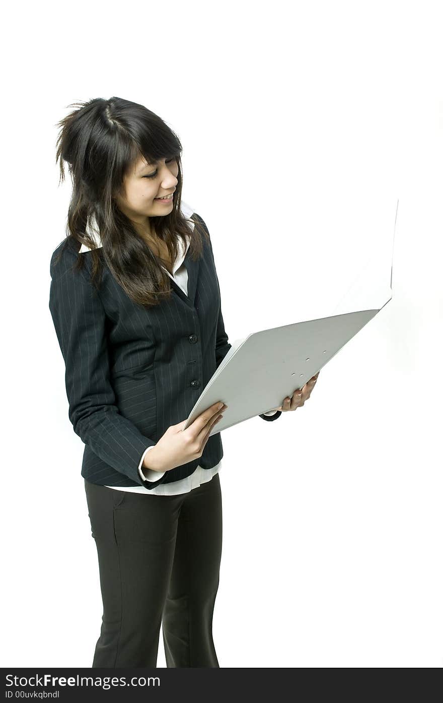 A young pretty businesswoman holding a file in the studio. A young pretty businesswoman holding a file in the studio