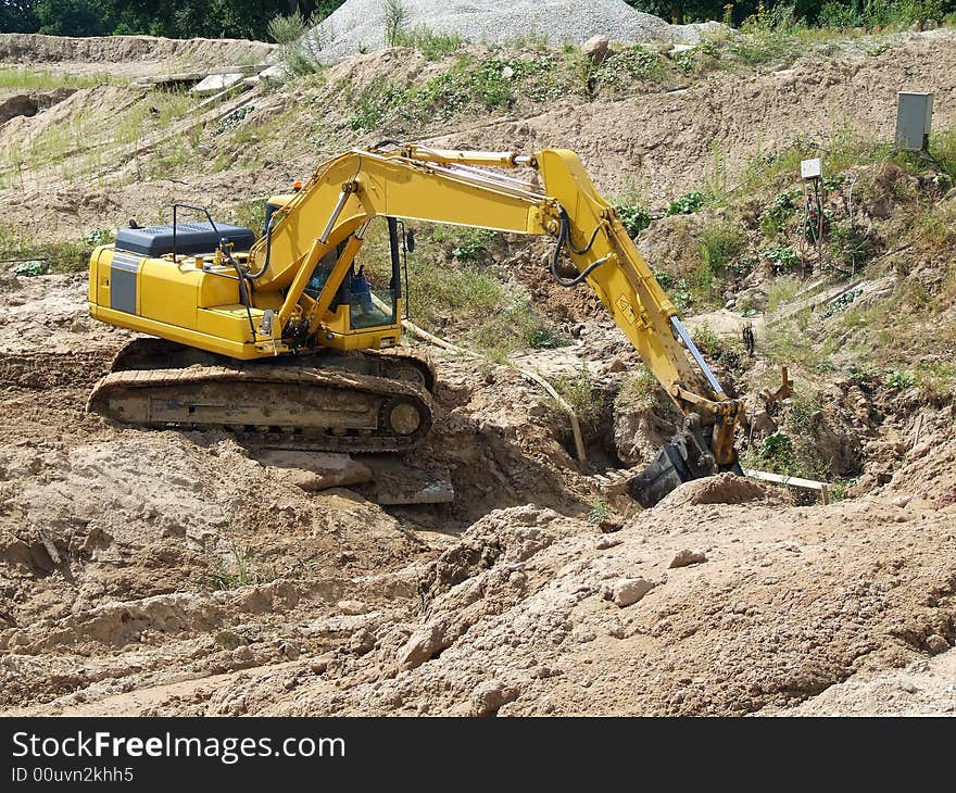 Excavator unloading concrete rubble on urban construction site