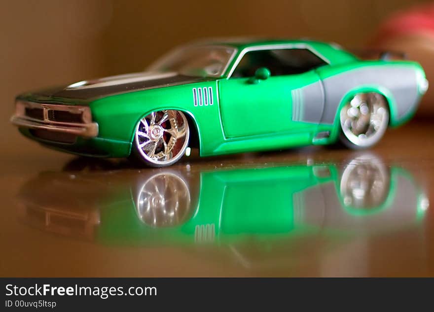 The reduced model of the ancient green car on a dark background