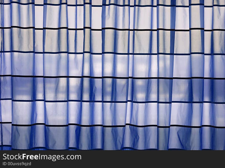 Blue stripped curtains helded in front of a window. Blue stripped curtains helded in front of a window