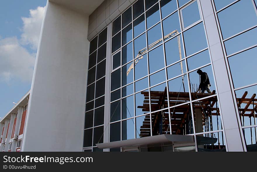 A worker in reflection on the windows