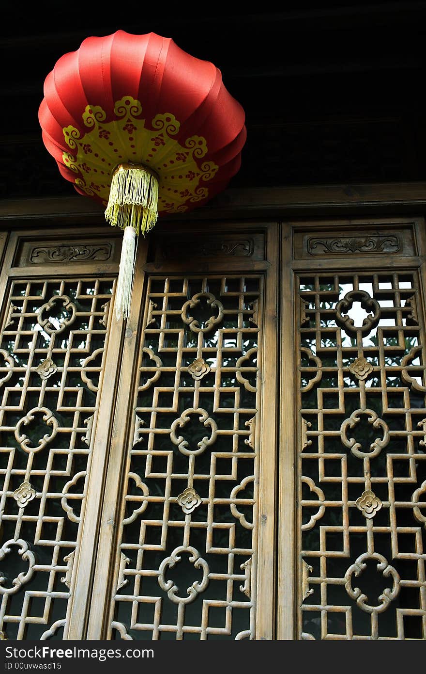 A red lantern hanging by the window