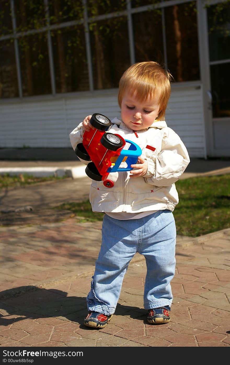 Nice little girl plays whith bright toy