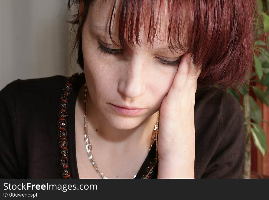 Thinking business woman in office