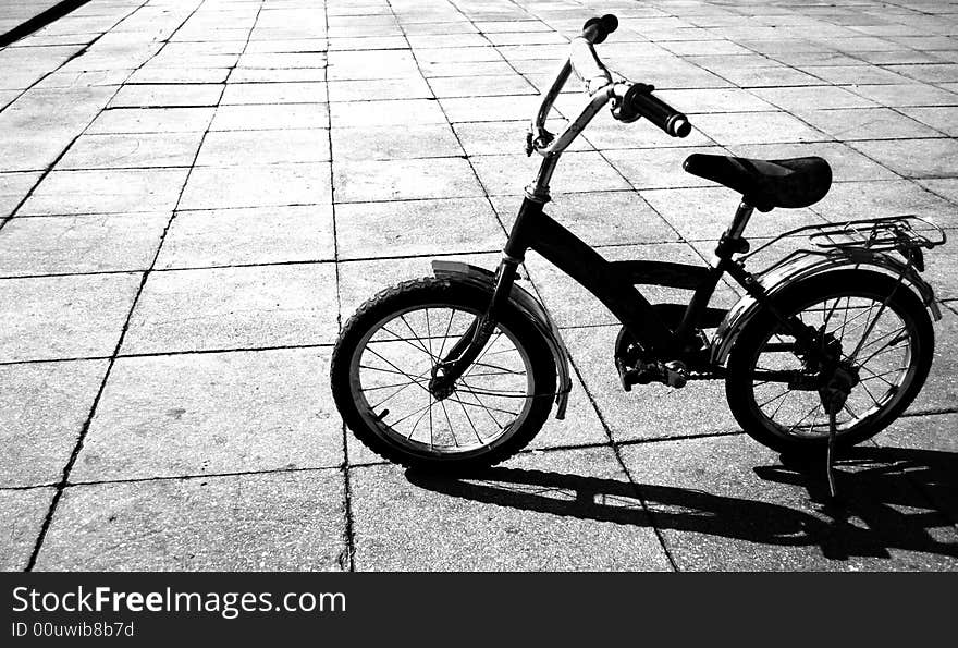 Bicycle is on the road under the summer sun polyaschim