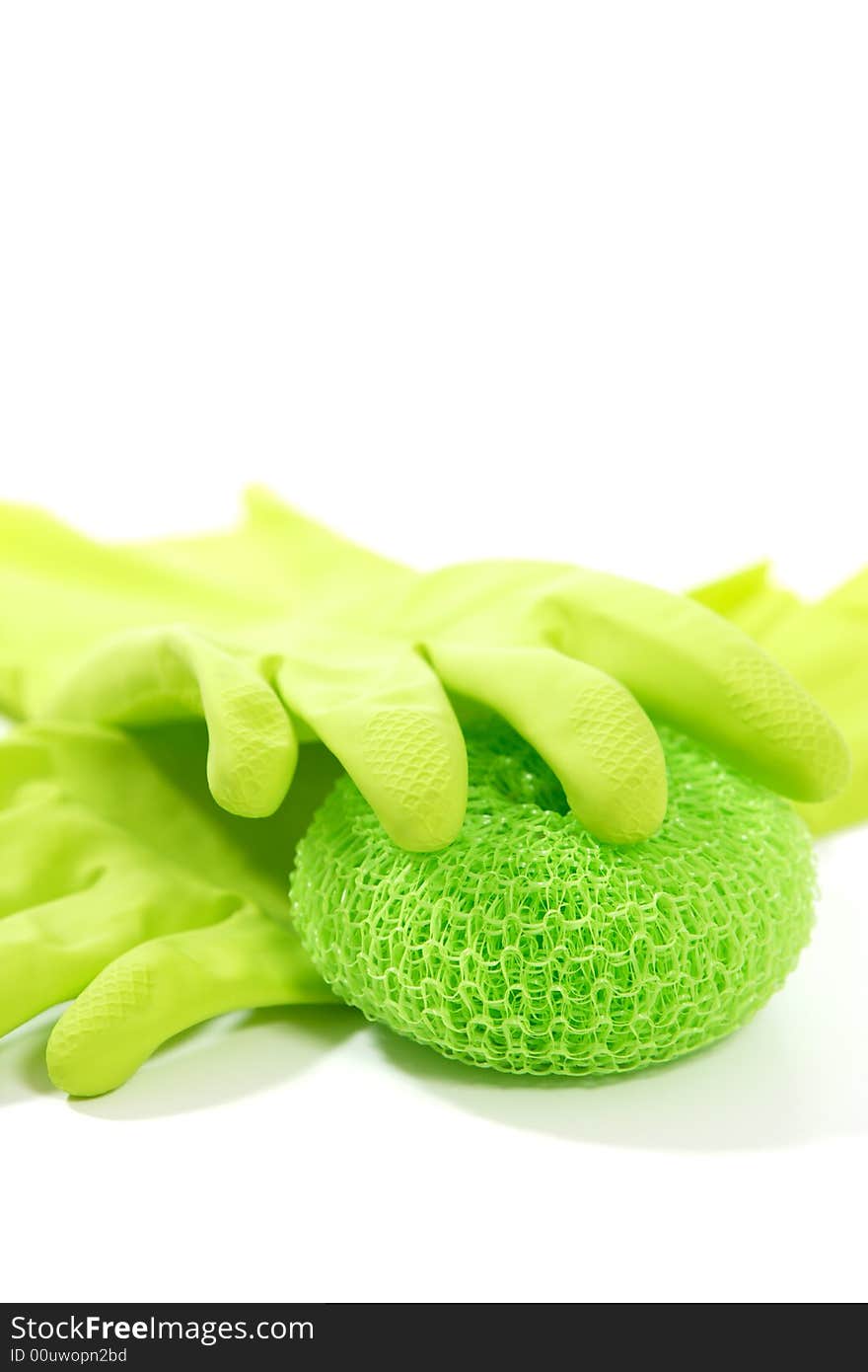 Green rubber gloves and a scrub pad close up in the studio. Green rubber gloves and a scrub pad close up in the studio