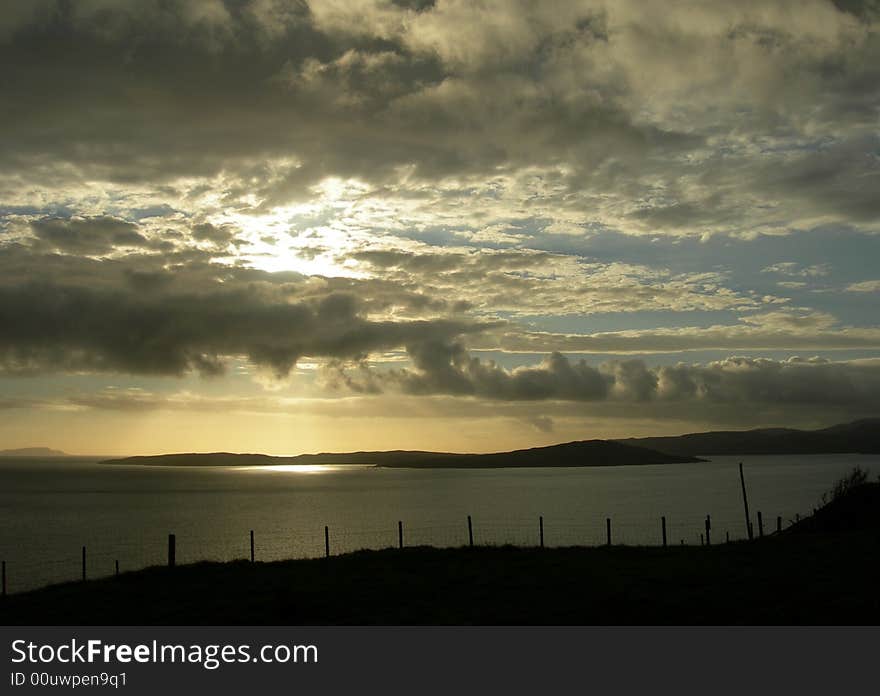 Scottish sunset during travel on the isle of Skye. Sun circle in the middle of the atlantic ocean