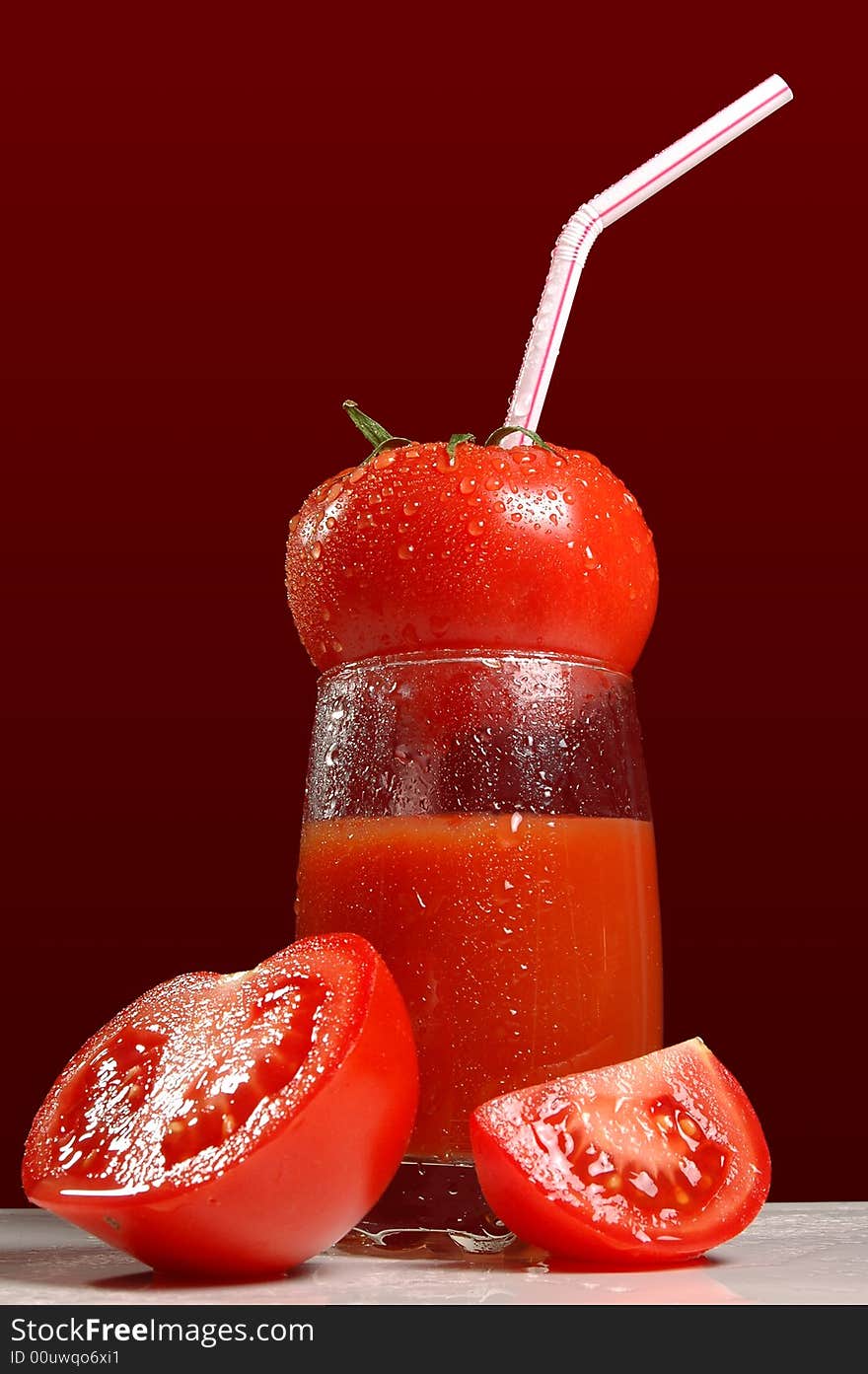 Tomatoes and tomato juice isolated on dark red background. Tomatoes and tomato juice isolated on dark red background