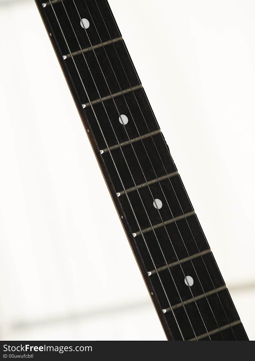 Finger board of an electric guitar isolated in white