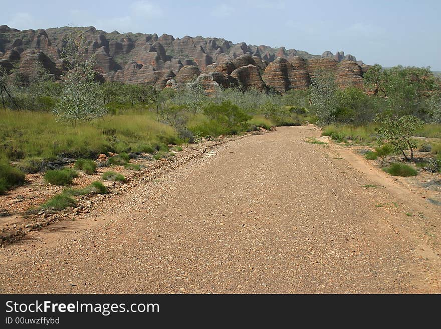 Australian country road with geological feature of rolling hills. Bungle Bungle national park, Western Australia, Australia. Australian country road with geological feature of rolling hills. Bungle Bungle national park, Western Australia, Australia