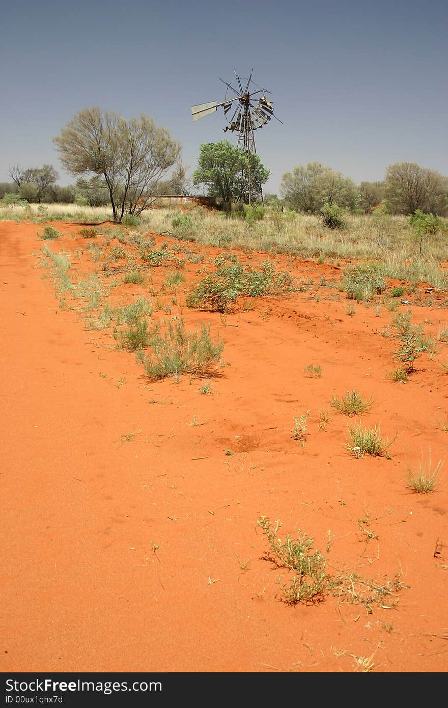 Destroyed Windmill with red sand and shrubby plants. Tanami road, Northern Territory. Australia. Destroyed Windmill with red sand and shrubby plants. Tanami road, Northern Territory. Australia